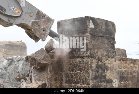 Sellin, Germany. 09th Dec, 2020. An excavator with hydraulic chisel hammers at the old NVA bunker while it is being demolished. The 300 square metre GDR bunker made of one metre wide concrete walls was built in 1959. Until 1988 it was part of the Technical Brigade Coast on the island of Rügen and was part of the radio and airspace surveillance in the Baltic Sea area. The cost of the demolition work is currently estimated at around 120 000 euros. Credit: Stefan Sauer/dpa-Zentralbild/dpa/Alamy Live News Stock Photo