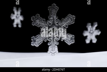 Single Snowflake close-up. Macro photo. The concept of winter, cold, beauty of nature. Copy space. Stock Photo