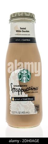 Winneconne, WI -6 December 2020: A bottle of Starbucks frappuccino coffee drink in toasted white chocolate flavor on an isolated background. Stock Photo