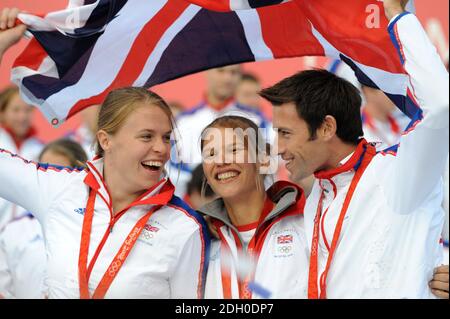 (from left to right) Great Britain's Women's Double Scull's Bronze Medalists Anna Bebington and Elise Laverick celebrate with Gold medalist Tom James during the parade for Britain's Olympic and Paralympic athletes through the streets of London. Stock Photo