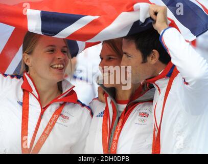 (from left to right) Great Britain's Women's Double Scull's Bronze Medalists Anna Bebington and Elise Laverick celebrate with Gold medalist Tom James during the parade for Britain's Olympic and Paralympic athletes through the streets of London. Stock Photo