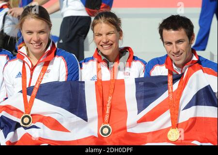 (from left to right) Great Britain's Women's Double Scull's Bronze Medalists Anna Bebington and Elise Laverick celebrate with Gold medalist Tom James during the parade for Britain's Olympic and Paralympic athletes through the streets of London. Stock Photo