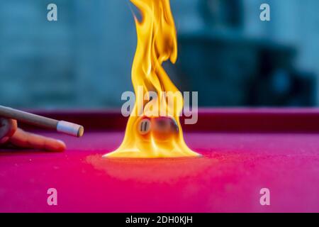 Pool Balls Are Lit On Fire While Sitting On A Pool Table In An Outdoor Environment Stock Photo