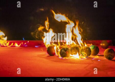 Pool Balls Are Lit On Fire While Sitting On A Pool Table In An Outdoor Environment Stock Photo