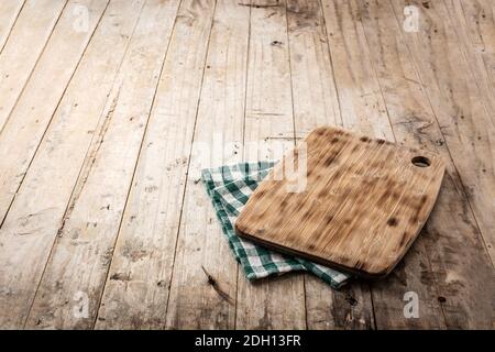 Cutting board mockup and green tablecloth on wooden table Stock Photo