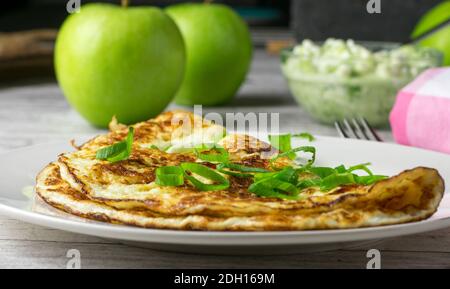 healthy dish with egg white omelet and chives served on a kitchen table Stock Photo