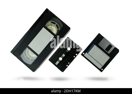 Videocassette audio cassette tape and floppy disk on white background Stock Photo