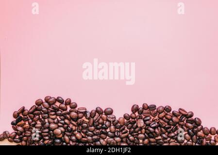 Coffee beans on simple pink background Stock Photo