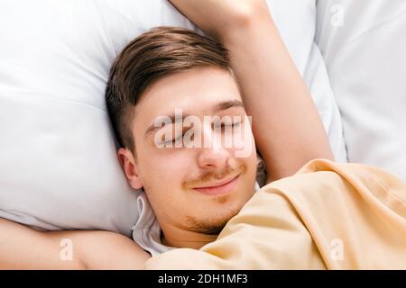 Young Man sleep in the Bed at the Home Stock Photo