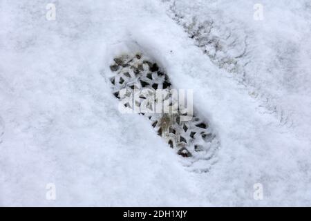Shoe print on freshly fallen white snow. Stock Photo