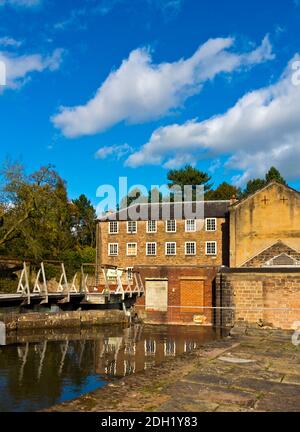 Factory buildings at Cromford Mill the world's first water powered cotton mill built by Richard Arkwright in 1771 in Cromford Derbyshire England UK Stock Photo