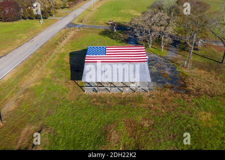 An American Flag  Painted On A Barn Near A Country Road Stock Photo