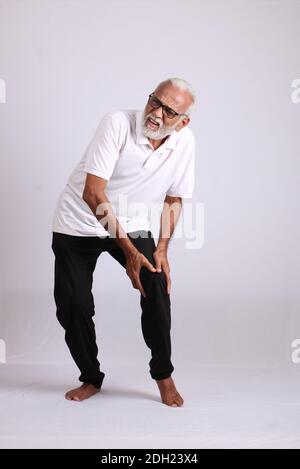 Indian asian old man having pain or ache sad expressions Stock Photo
