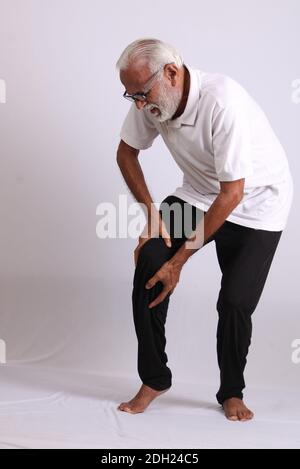 Indian asian old man having pain or ache sad expressions Stock Photo