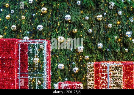 Christmas Tree with Decorations Lights and Gift Boxes Stock Photo