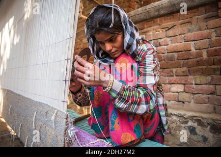Woman in India has many responsibilities as taking care of their children, cooking, washing, working, also receiving training for income generating ac Stock Photo