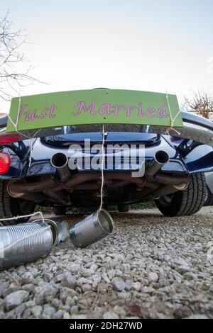 Rear view of a Vintage wedding car with just married sign and cans attached Stock Photo