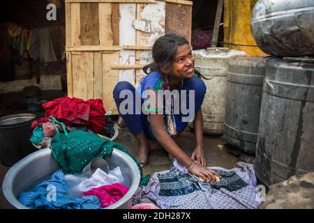 Female adolescents in India they already have to participate in their housing duties, such as cooking and washing cloths. Stock Photo