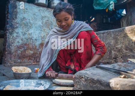 Female adolescents in India they already have to participate in their housing duties, such as cooking and washing cloths. Stock Photo