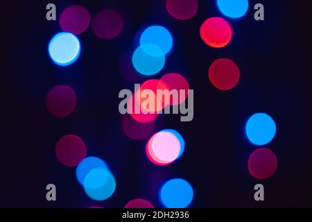 Red blue and purple bokeh dots on black background, colorful circles to use for photo image manipulation Stock Photo