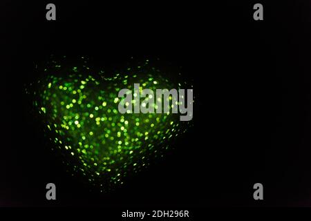 On black isolated background green blurred heart from bokeh. Greeting card. Texture for website, banner, poster. Template preparation for Valentine's, Stock Photo