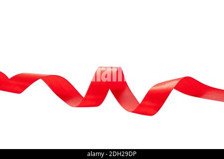 Red ribbon curly isolated cutout on white background, silk band christmas decoration. Valentine day, birthday or xmas presents concept. Stock Photo