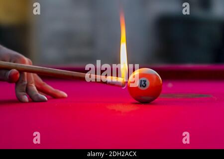 Pool Balls Are Lit On Fire While Sitting On A Pool Table In An Outdoor Environment Stock Photo