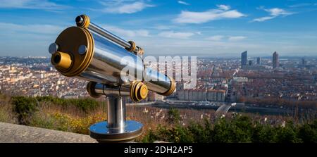 Telescope and panoramic view at Lyon city from Fourviere hill viewpoint. France.