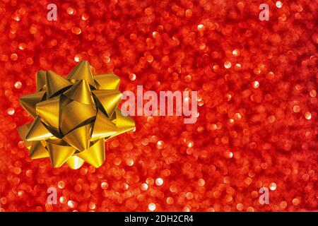 golden bow on a red background with a side. congratulations, gift. holiday, new year, February 14 Stock Photo
