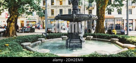 European architecture and fountain in city park in Zurich, Switzerland Stock Photo