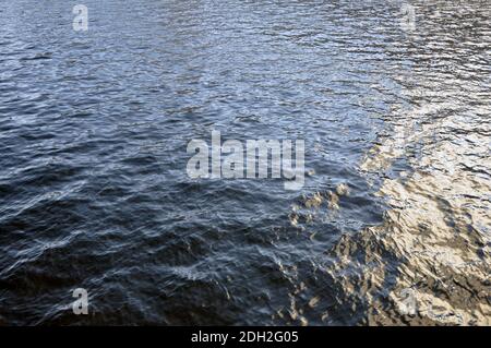 Cold waters of winter rivers with reflections of the setting sun. Stock Photo