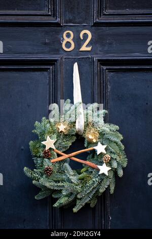 Detail of traditional Christmas wreath on front door of house in New Town of Edinburgh, Scotland, UK Stock Photo