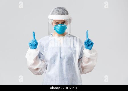 Covid-19, preventing virus, health, healthcare workers and quarantine concept. Determined young doctor or nurse working with pat Stock Photo