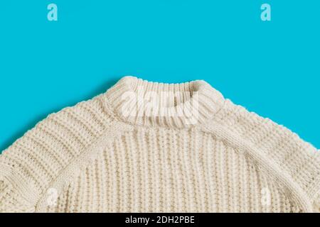 Woolen knitted patterned sweater fabric textile texture on a bright blue background Stock Photo