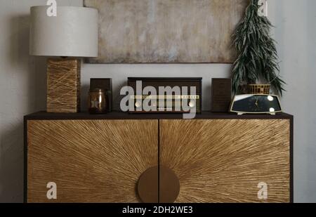 Retro radio and table lamp on wooden counter Stock Photo