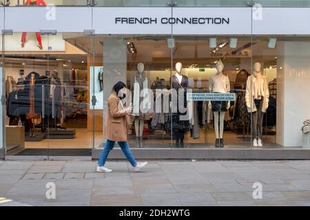 A pedestrian walking pass a branch of the fashion retailer French Connection. Stock Photo