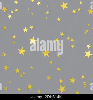 Illuminating stars confetti on holiday Ultimate Gray background. Color year 2021. Golden sparkles magic backdrop. Flat lay. Stock Photo
