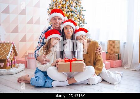 Happy young family with kids holding christmas presents Stock Photo