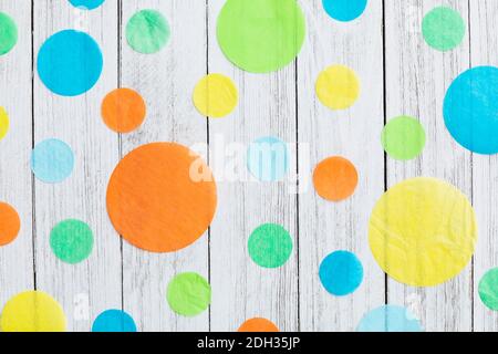 Customizable background with colorful paper circles on a wooden surface for festive occasions Stock Photo