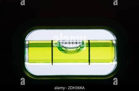 Tool measuring levelness with clear liquid and air bubble in calibrated device view Stock Photo