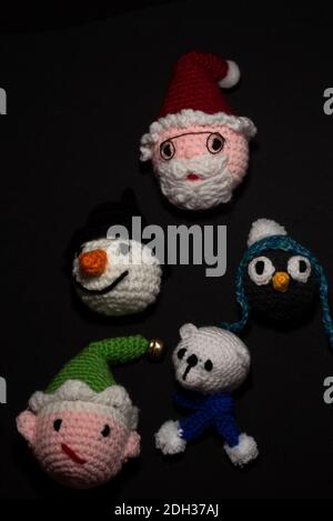 Portrait of Christmas Amigurumi crocheted or knitted stuffed toy on black background Stock Photo
