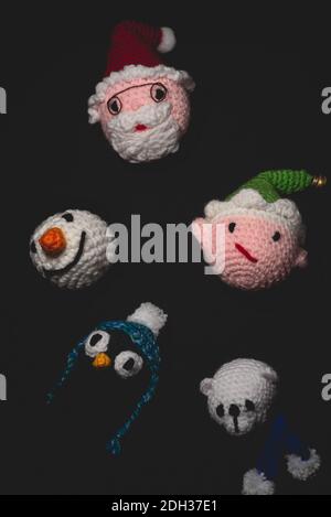 Portrait of Christmas Amigurumi crocheted or knitted stuffed toy on black background Stock Photo