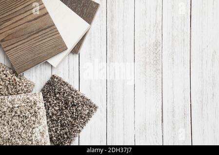 Variety of flooring samples displayed on a wooden surface for interior design inspiration and selection Stock Photo