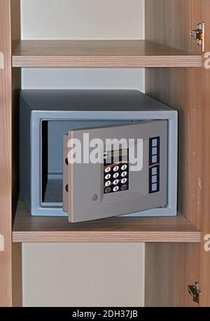 Modern digital pass code empty safe with open door on shelf in a hotel Stock Photo