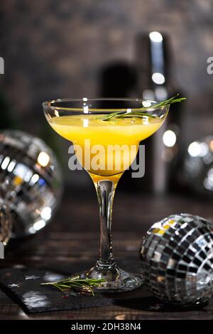 Mimosa coctail with orange juce and champagne in trendy colors gray and Illuminating yellow of the 2021. New Year or Birthday party with a mirror disc Stock Photo