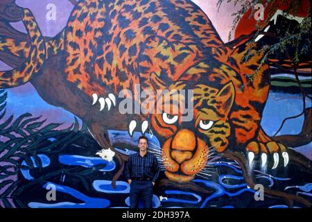 Ray Manzarek, keyboardist for the Doors, poses in front of a Venice Beach mural in Los Angeles, CA while filming the video for L.A. Woman in 1984 Stock Photo