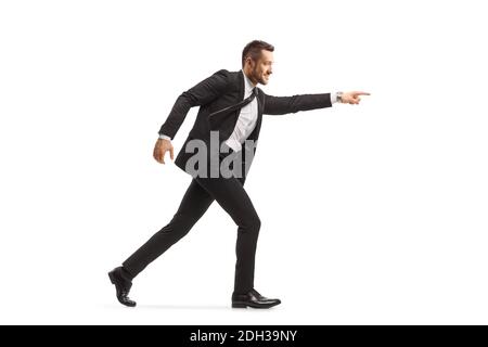 Businessman running and pointing forward isolated on white background Stock Photo