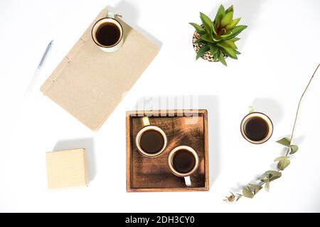Mango wood wooden tray with four espresso coffee cups on the white background. Empty space Stock Photo
