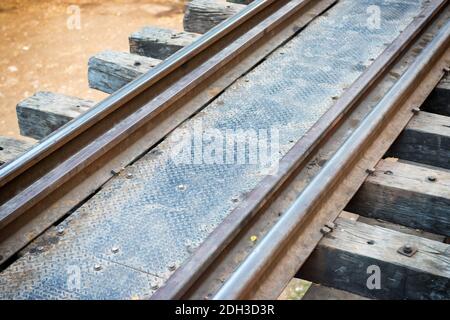 Old rail track with wooden sleepers and rusty rails Stock Photo