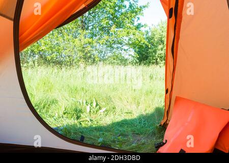 View from inside tent to green lawn Stock Photo